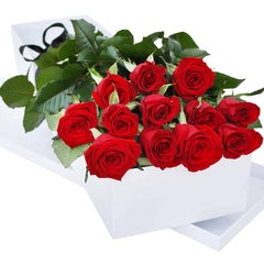 A classic gift box of 12 red roses, hand-delivered with a gift card, exuding timeless romance.