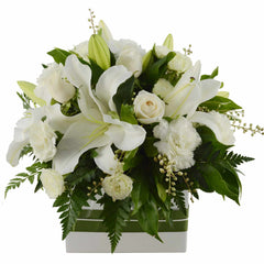A stunning white box of asiatic lilies, roses, spray roses, and sim carnations for a pure, elegant look.