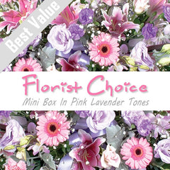 A soft pink and lavender mini box of fresh seasonal flowers, arranged with greenery for a romantic surprise.