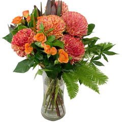 Sunrise Dreams: Autumn-toned bouquet with spray roses, disbuds, and leucadendrons.