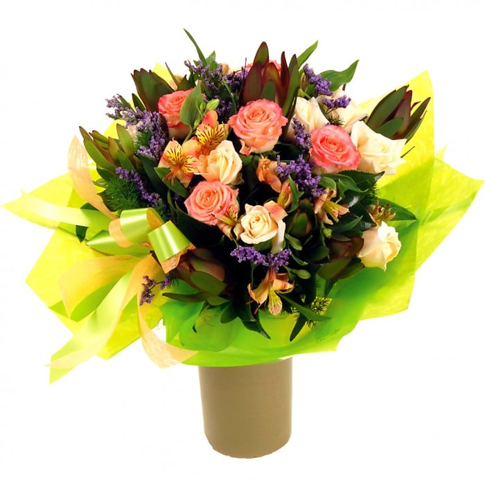 Surprise Bouquet: Purple and pink bouquet with leucadendron, roses, and camellia leaves.