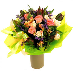 Surprise Bouquet: Purple and pink bouquet with leucadendron, roses, and camellia leaves.