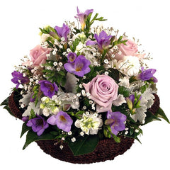 Swan Lake Basket Arrangement: Pink, purple, and white basket arrangement with roses and freesias.