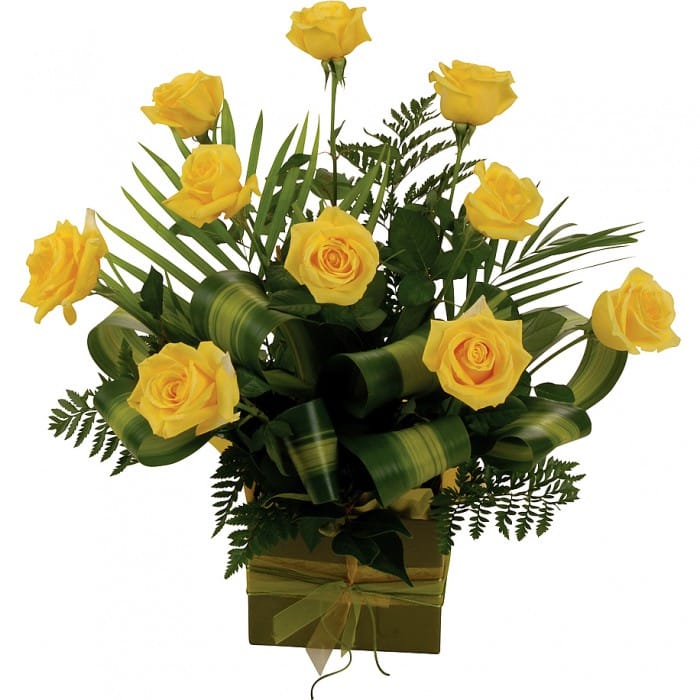 Yellow Roses Arrangement- 10 Roses: Box arrangement of 10 medium-stem yellow roses with tropical leaves.