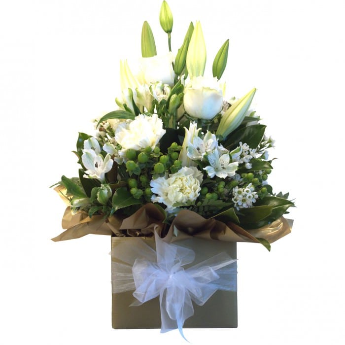 Christmas Flowers - Mrs Clause: White and gold box arrangement with roses, lilies, and berries.