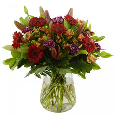 Sunset Seasons: Autumn-toned bouquet with mini gerberas, lilies, and alstroemeria.
