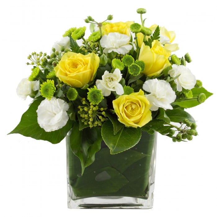Lots Of Joy Yellow Flowers in Cube Vase: Yellow and white flowers in a glass cube vase.
