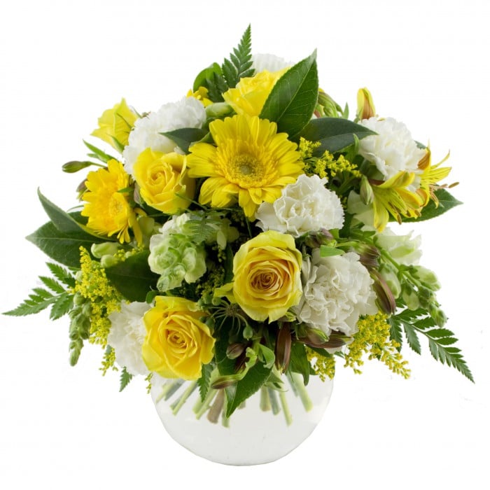 Bananarama Yellow Bouquet in Vase: Yellow and white bouquet in a fishbowl vase with carnations, roses, and gerberas.