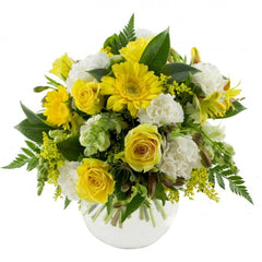 Bananarama Yellow Bouquet in Vase: Yellow and white bouquet in a fishbowl vase with carnations, roses, and gerberas.