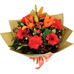Blushing Bunch: Orange bouquet with gerberas, carnations, lilies, berries, and beech.