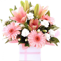 A best-selling pink and white mini box of mini gerberas, lilies, and spray carnations for a charming surprise.