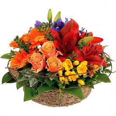 Elegance Basket Arrangement: Orange, yellow, and purple basket arrangement with roses, lilies, and freesias.